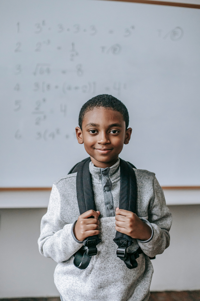 Smiling black boy in classroom